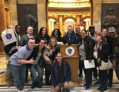 People posed at a podium in a nice building