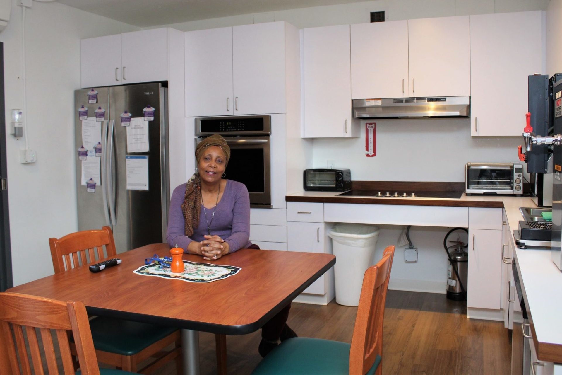 Yolette sitting in the kitchen of Betty's Place - our transitional housing program